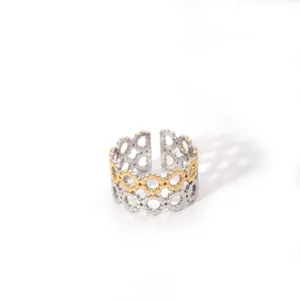 Detail of interlocking triple-layer镂空 geometric ring with gold and silver dual-tone finish