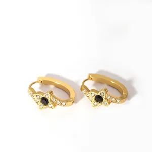 Macro detail of 18K gold-plated clover hoop earrings with black stone and pave crystals