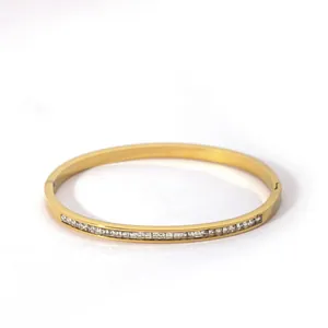 Macro detail of gold plated bracelet with square zircon stones and invisible clasp