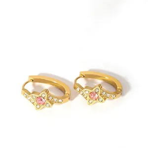 Detail of 18K gold star hoop earring with a pink center stone and white zircon accents