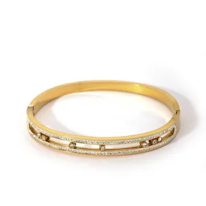 Detailed close-up of a gold-plated copper bangle with hollow layers and zircons