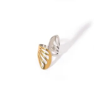 Detail of two-tone gold and silver open ring with hollowed wing design in stainless steel