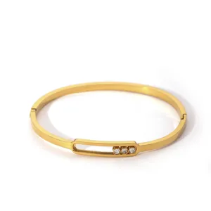 Detail shot of a gold-plated copper bangle with three sparkling cubic zirconia insets