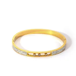 Close-up of gold-plated copper bangle with pave-set zircons and circular crystal details