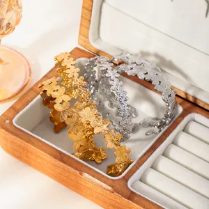 18k gold and silver stainless steel open bangle with textured daisy floral pattern