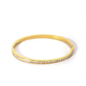 Detail of gold zircon bracelet with shell inlay and secure side clasp closure