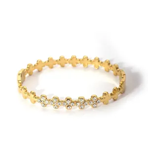 Detail of 18K gold plated stainless steel hinge bracelet with cross pattern and crystals
