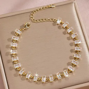 Detailed close-up of zircon link bracelet with rectangular step-cut stones on gold chain