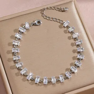 Detailed macro view of silver-tone bracelet with rectangular cubic zirconia and lobster clasp