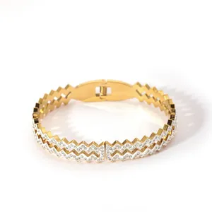 Detail of 18K gold plated stainless steel wavy bracelet with shimmering pavé zircon stones