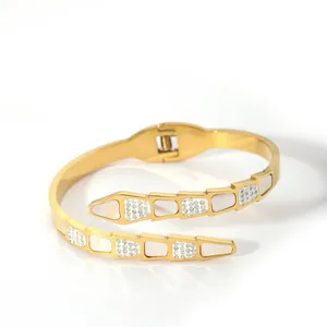 Detail of gold snake bangle with mother-of-pearl inlay and crystal pavé hinge