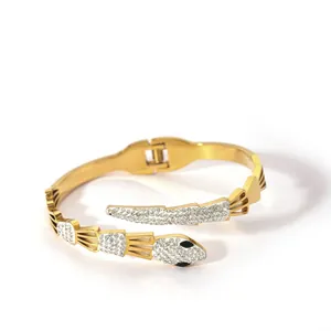 Macro view of gold snake bracelet with sparkling pavé crystals and segmented texture
