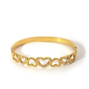 Close-up of gold heart bracelet with cubic zirconia inlay and hinged opening mechanism