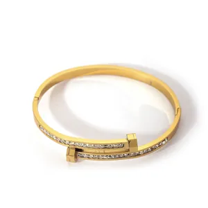 Macro detail of 18K gold-plated double-layer bangle with sparkling pave zircon settings