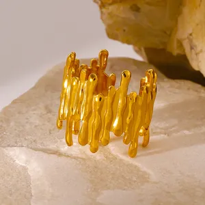 Lava style gold plated titanium steel ring featuring fluid molten metal design on stone