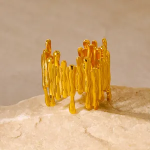 Detailed view of gold plated lava ring with fluid texture on creamy natural stone