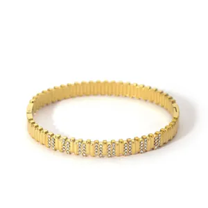 Macro shot of 18K gold plated ribbed stainless steel bracelet with zircon inlay