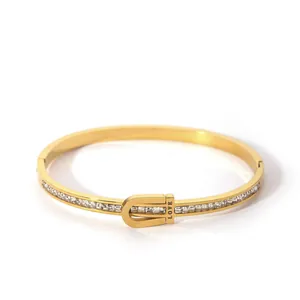 Detail of gold-plated buckle bangle with square zircons and LOVE engraving