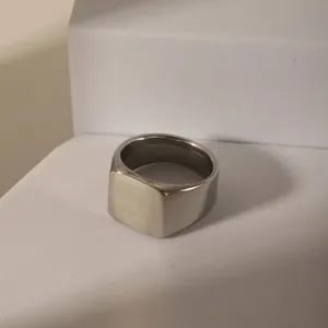 Minimalist silver stainless steel signet ring with a brushed matte square flat top surface