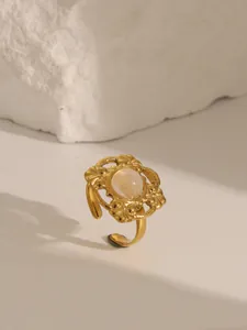 Detail of vintage 18K gold plated ring featuring turquoise setting and hollow carving