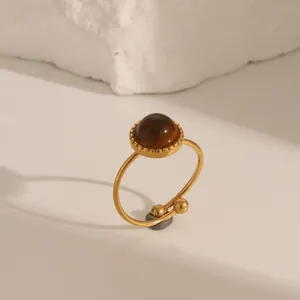 Vintage stainless steel ring featuring a round brown gemstone inlay and gold finish
