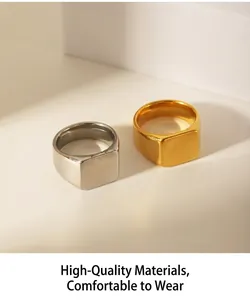 Detail view of gold and silver square signet rings with matte finish on geometry block