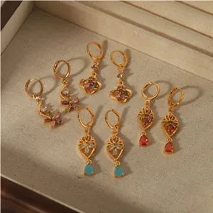 Set of four gold stainless steel huggie earrings with colorful gemstone drops