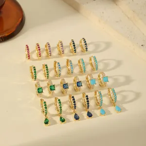 Elegant gold-plated hoop earrings with multi-color zircon stones on white stone