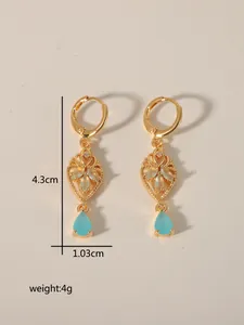 Detail view of gold vintage heart earrings with blue gemstones and 4.3cm size marking