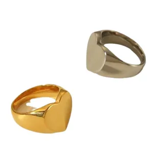 Minimalist heart signet rings in polished gold and silver stainless steel finishes