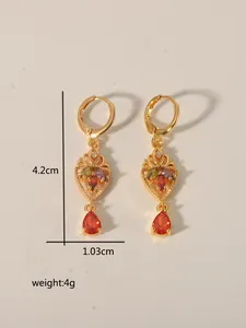 Retro hollow heart earrings with red teardrop gems showing size of 4.2cm by 1.03cm