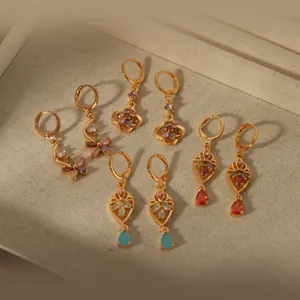 Elegant gold earrings set featuring colorful gemstones and intricate hollow floral designs
