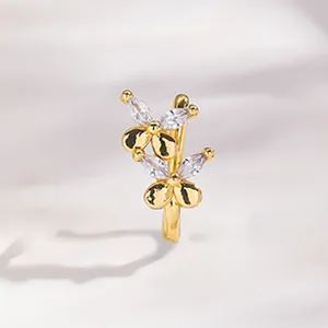 Detail of flower non-pierced nose ring featuring gold plating and marquise cut zircon stones