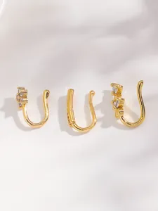 Detailed macro view of three gold-plated non-piercing nose cuffs with cubic zirconia inlay