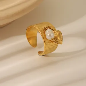 Minimalist wide gold-plated open ring with heart charm and pearl on brushed metal