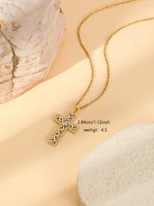 Gold stainless steel cross pendant necklace with sparkling rhinestones and delicate detail.