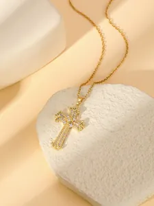 Detailed close-up view of gold stainless steel cross pendant necklace with sparkling crystal stones.