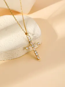 Close-up detail of the gold-plated cross pendant necklace with sparkling zirconia.