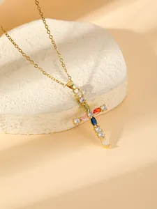 Close-up detail of a gold-plated cross necklace featuring sparkling multi-color cubic zirconia.
