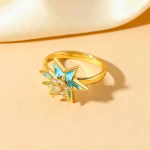 Gold-plated stainless steel star ring with light blue enamel and sparkling crystals