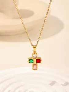 Close-up of gold stainless steel cross necklace with colorful crystal stones, detail jewelry view