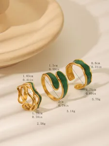 Detail view of vintage gold-plated rings with green oil drip and irregular wavy edges