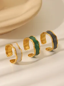 Detailed view of adjustable wavy rings with gold plating and colorful enamel finish