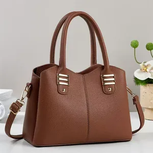 Classic brown lychee leather handbag with gold hardware and adjustable strap for women