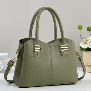 Elegant green litchi grain leather handbag with gold accents and adjustable strap