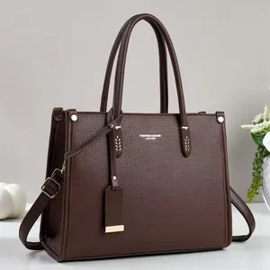 Elegant dark brown pebble leather tote bag with dual handles and adjustable shoulder strap