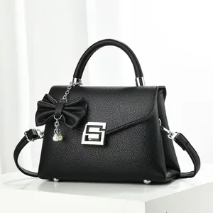 Elegant black lychee pattern leather handbag with pearl bow charm and silver square buckle
