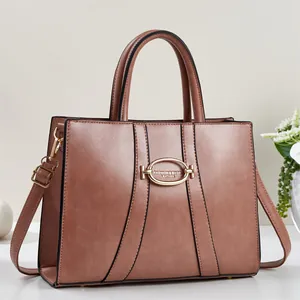 Fashionable dusty pink leather tote bag with gold hardware and contrast stitching