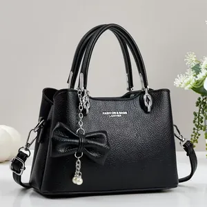 Black lychee pattern faux leather handbag with pearl bow charm and silver hardware