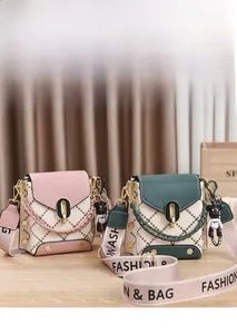 Détail de mini sacs à bandoulière matelassés avec sangle en toile et pendentif ours
